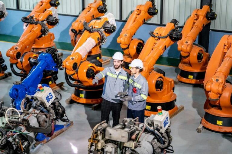 engineer-inspecting-automatic-ai-robot-arm-and-mac-2023-11-27-05-17-29-utc